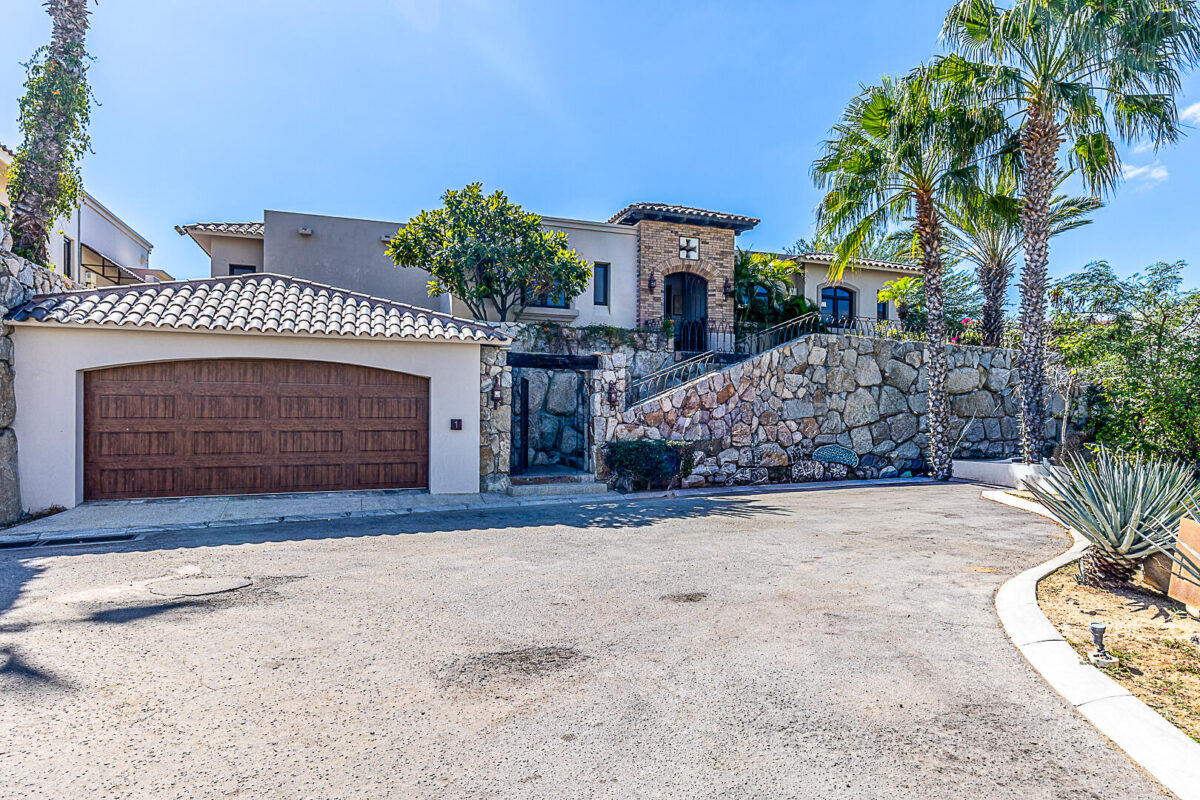 Los Cabos Hermitage Villa No. 1 features a street-level garage with space for two large vehicles. From the garage, a staircase leads up to the villa, where the entire residence is laid out on a single level.The villa offers four bedrooms and four bathrooms, although one of the bedrooms has been converted into a television room. It also includes a living room, dining room, kitchen, pantry, laundry room, service room with a full bathroom.The outdoor areas feature a covered terrace, garden, swimming pool, and jacuzzi. The villa is delivered fully furnished and equipped, including hurricane protection systems. – Hermitage Vía La Paloma, Cabo Corridor, BS