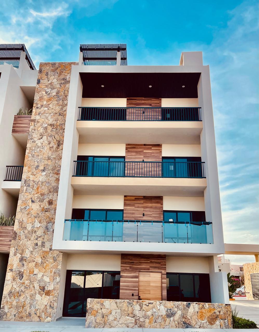 Los Cabos Brisas Del Tezal Ready for immediate delivery! Beautiful ground-floor 2BR/2BA condo in Brisas del Tezal, an exclusive low-density community of only 36 residences in two 4-story elevator buildings. Just minutes from Medano Beach, downtown Cabo, shopping, golf, and restaurants. Features premium finishes including marble floors, granite countertops, parota wood carpentry, floor-to-ceiling marble showers, pantry, laundry room, wall-to-wall closets, mini-split A/C throughout, and a spacious terrace. No adjoining side neighbors for exceptional privacy. Resort-style amenities include a heated pool, clubhouse, coworking space with Wi-Fi, BBQ area, playground, landscaped grounds, 24/7 security, and immediate occupancy. Ideal for full-time living, vacation use, or investment. – 2 bedroom Ground-Floor Close to the Pool, Cabo Corridor, BS